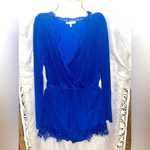 Beautiful, blue, detailed short jumpsuit with long sleeve